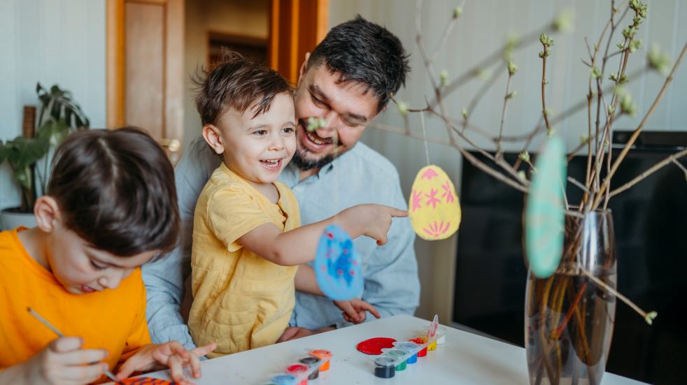 Father making Easter crafts with sons